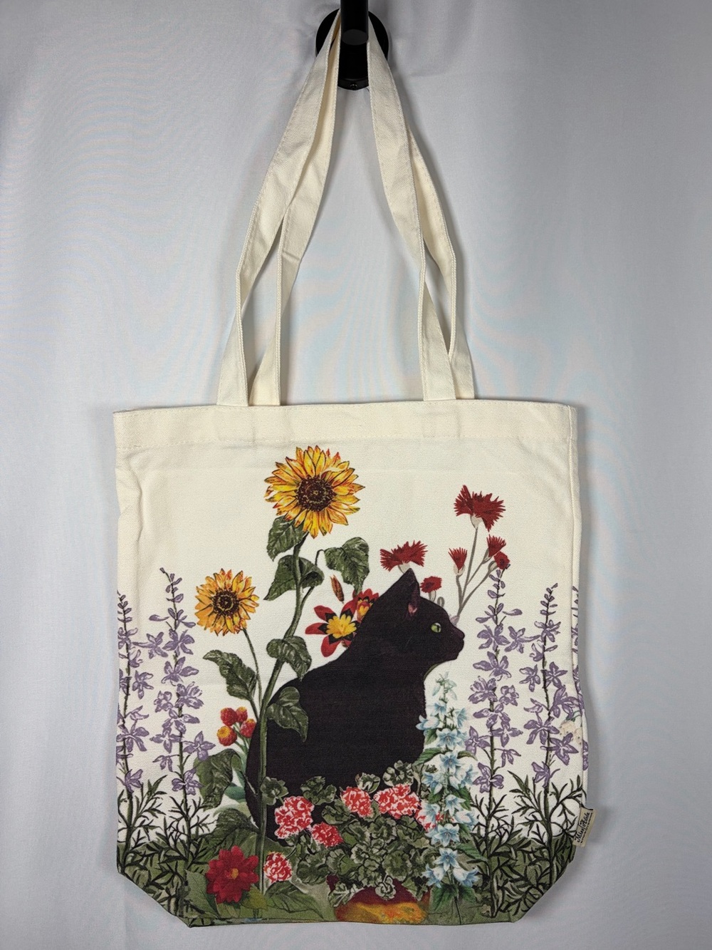 Miss Adola Black Cat in The Garden Canvas Print Shoulder Tote Bag